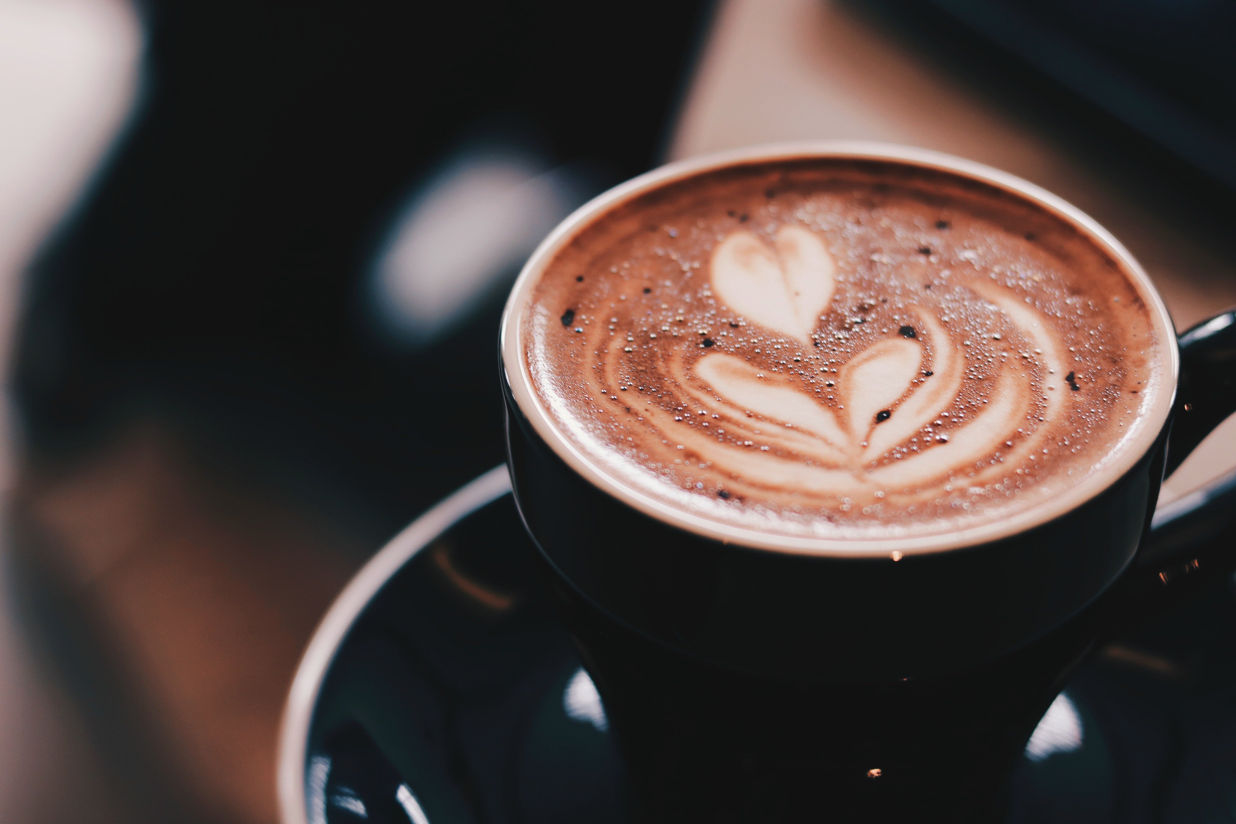 Coffee with latte art in black mug